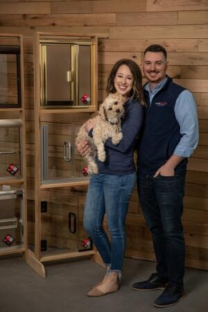 Glass Doctor of Lexington owners, Philip and Katelyn Schultz holding their dog.