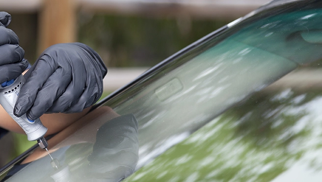 A closeup of a windshield on a white sedan.