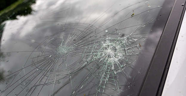 A picture of a broken windshield. 