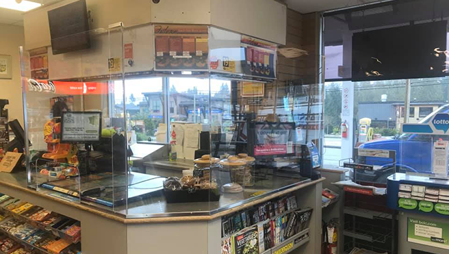 A picture of safety glass around a convenience store counter.