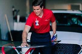 Glass Doctor professional wiping down windshield.