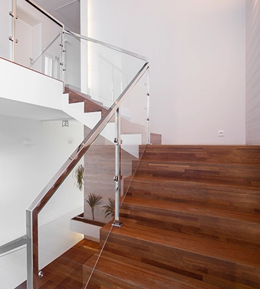 Solid wooden stairs with elegant glass balustrade