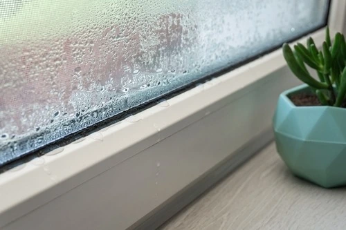 Close-up of condensation inside window.