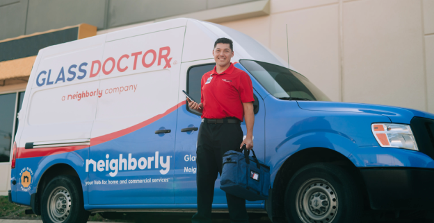 Glass Doctor technician at the door with the glass doctor van parked out front.
