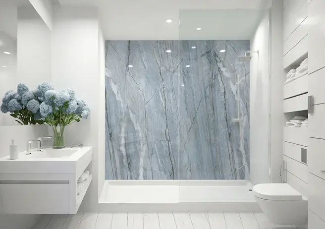 A white bathroom with a walk-in shower and a streaky blue shower wall by IMAGIO