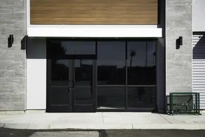 a glass storefront door with black bordering around it