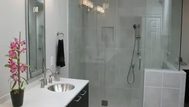 A modern bathroom with a frameless glass shower door